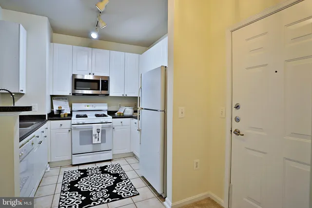 a kitchen with a sink cabinets and stainless steel appliances