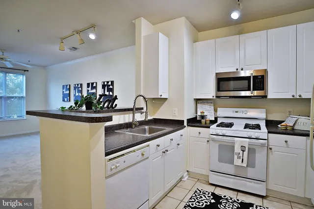 a kitchen that has a sink and a stove