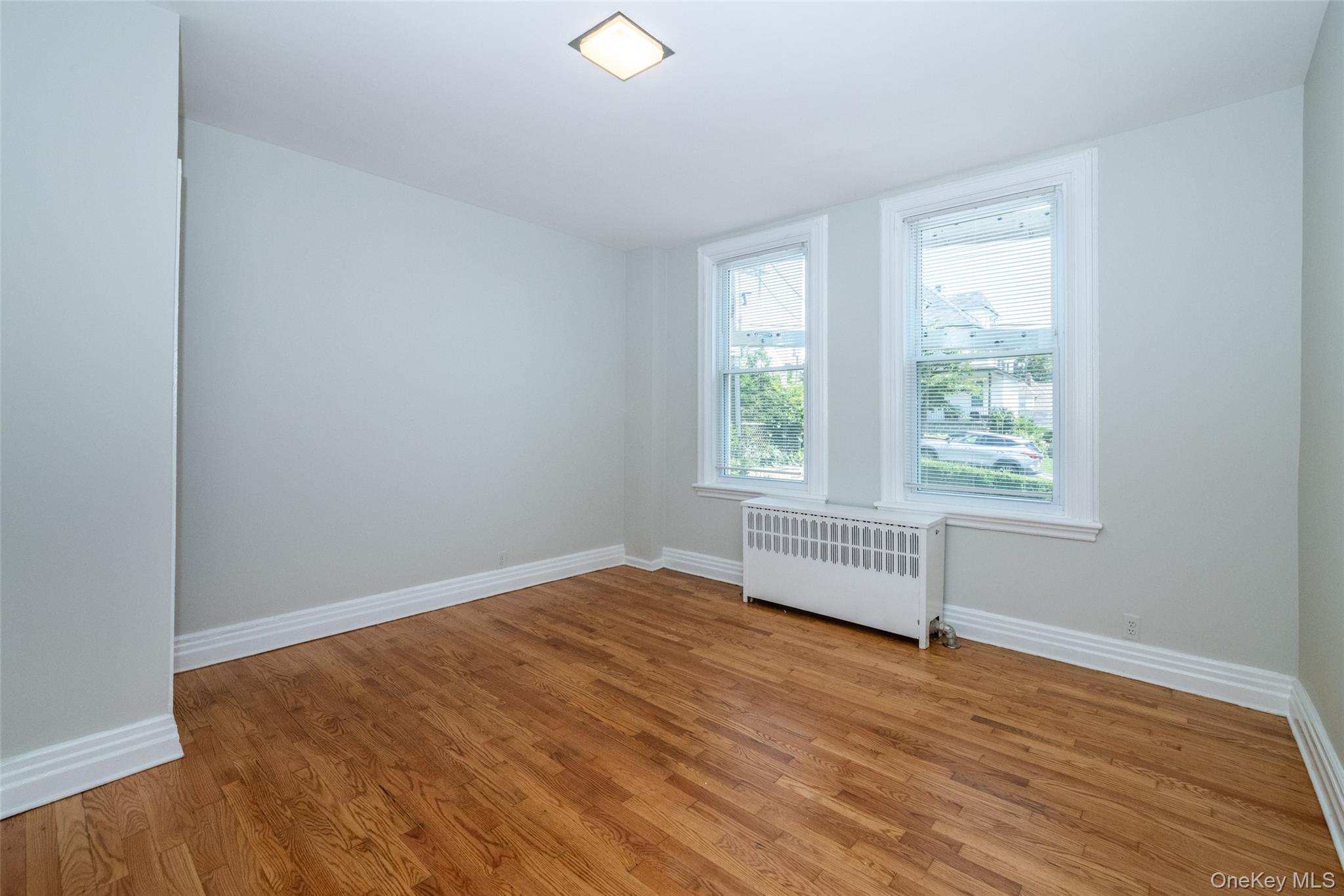 7 Alpha Place, Unit FIRST New Rochelle, NY 10805 - Photo 10 of 25 Spare room with radiator and light wood-type flooring