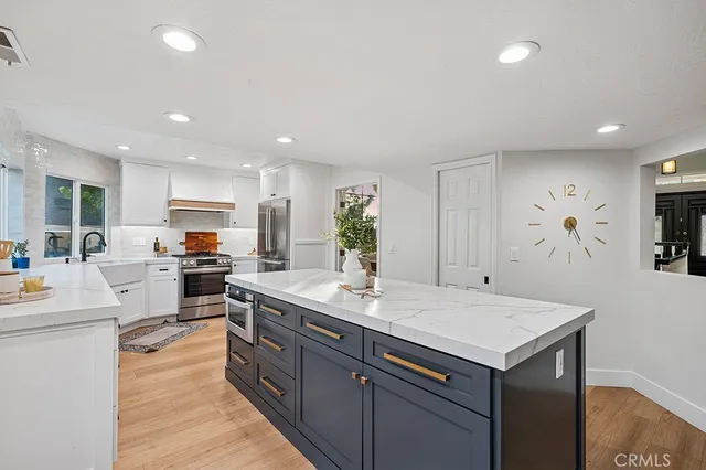 a kitchen with a sink microwave and cabinets
