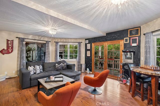 a living room with furniture a rug and a large window