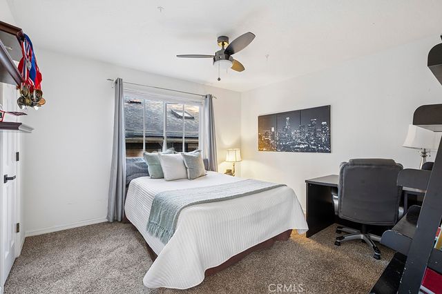 a bedroom with a bed and a desk