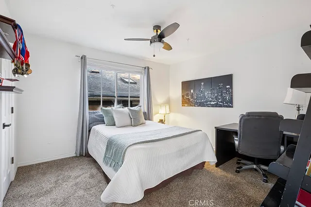 a bedroom with a bed and a desk