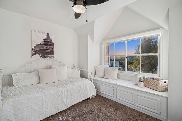 a bedroom with furniture and a large window