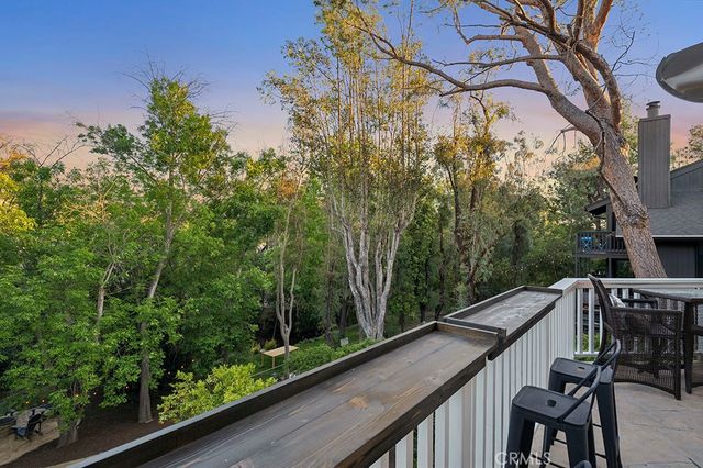 a view of balcony with furniture and wooden fence