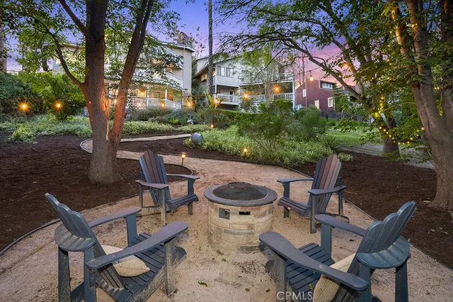 a view of a chairs and table in backyard