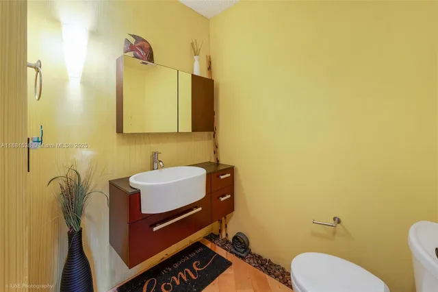 a bathroom with a toilet sink and mirror