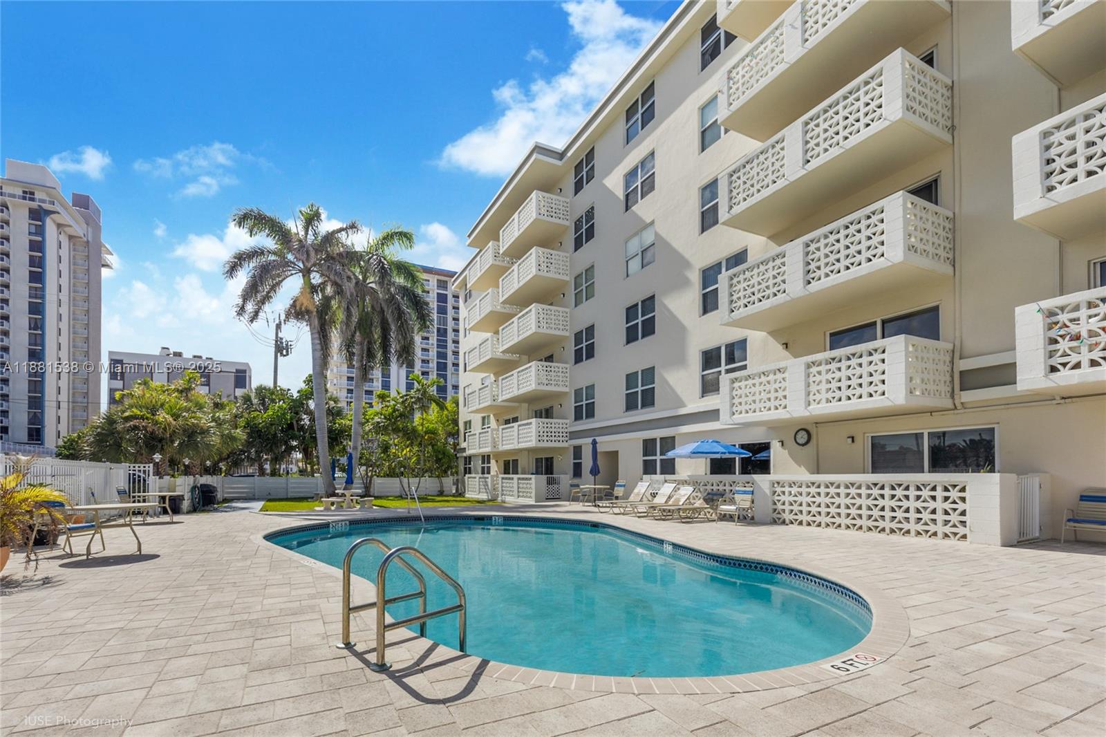 1901 South Ocean Drive, Unit 303 Hollywood, FL 33019 - Photo 4 of 29 a swimming pool with outdoor seating and yard