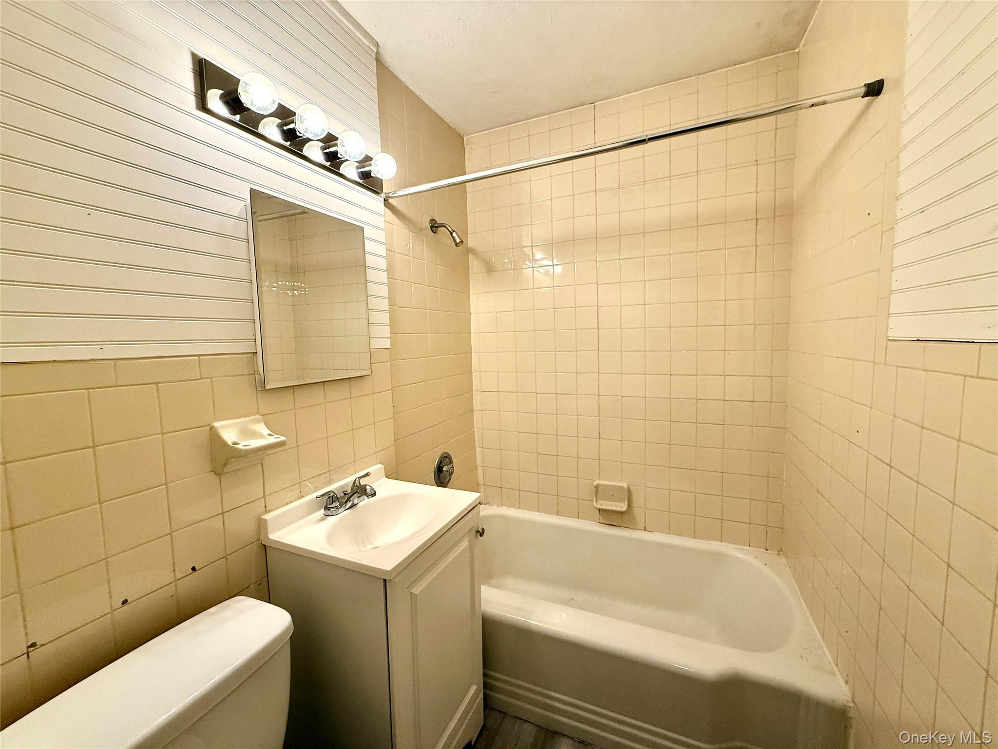 62 Talmadge Street, Unit 2 Poughkeepsie, NY 12601 - Photo 5 of 5 a bathroom with a sink a toilet and shower