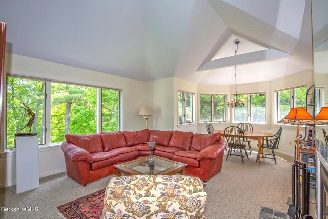a living room with furniture and large windows