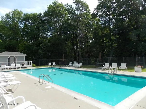 a view of a swimming pool with chairs