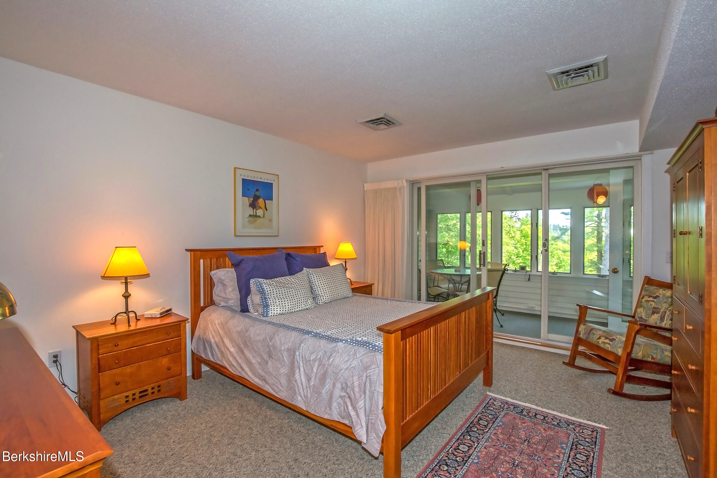 770 Summer Street, Unit 5D Lee, MA 01240 - Photo 17 of 45 a bedroom with a bed a lamp and a large window