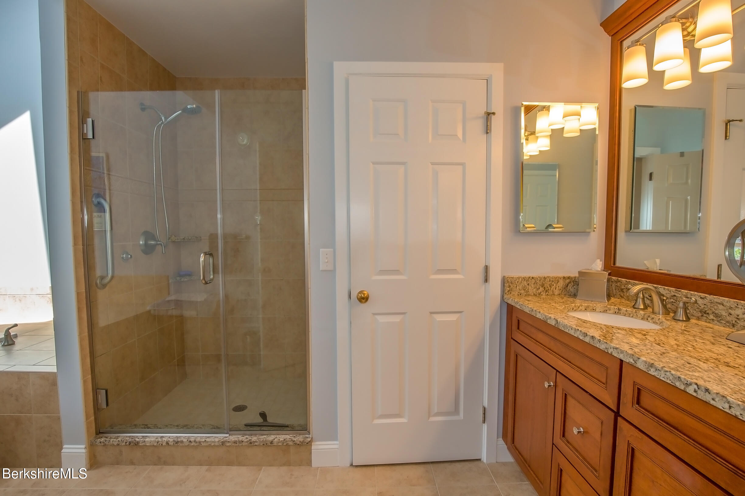 770 Summer Street, Unit 5D Lee, MA 01240 - Photo 19 of 45 a bathroom with a granite countertop sink a mirror and shower