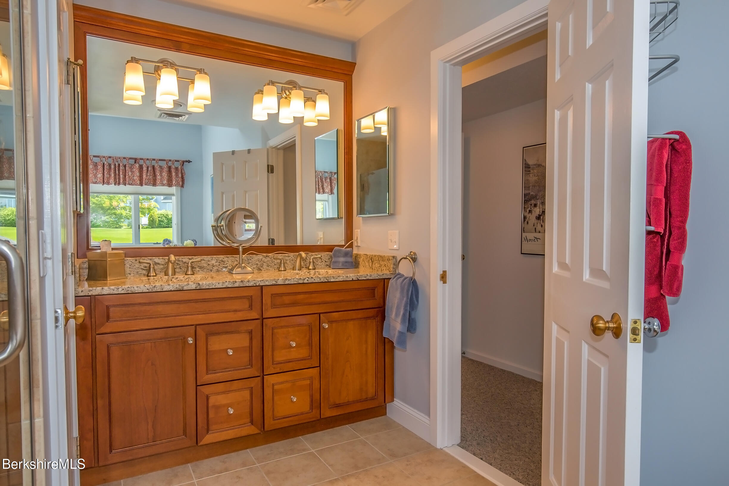 770 Summer Street, Unit 5D Lee, MA 01240 - Photo 21 of 45 a bathroom with a granite countertop sink a mirror and a next to a window