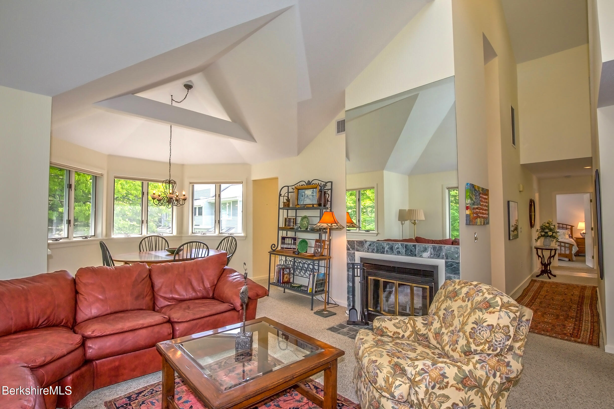 770 Summer Street, Unit 5D Lee, MA 01240 - Photo 23 of 45 a living room with furniture a fireplace and a large window