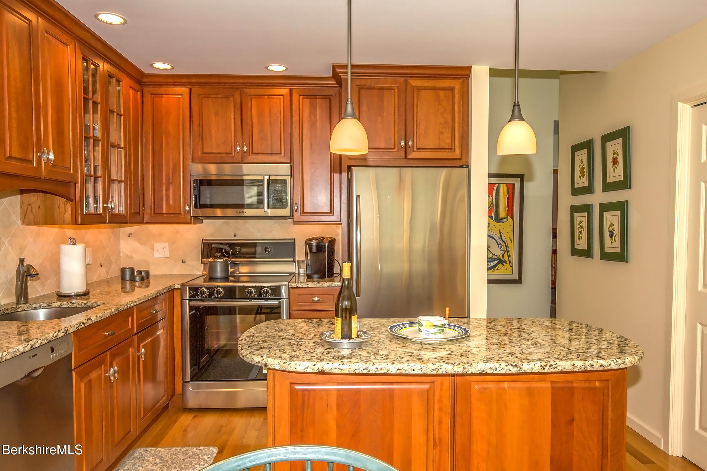 770 Summer Street, Unit 5D Lee, MA 01240 - Photo 7 of 45 a kitchen with stainless steel appliances granite countertop a sink a stove and a wooden cabinets
