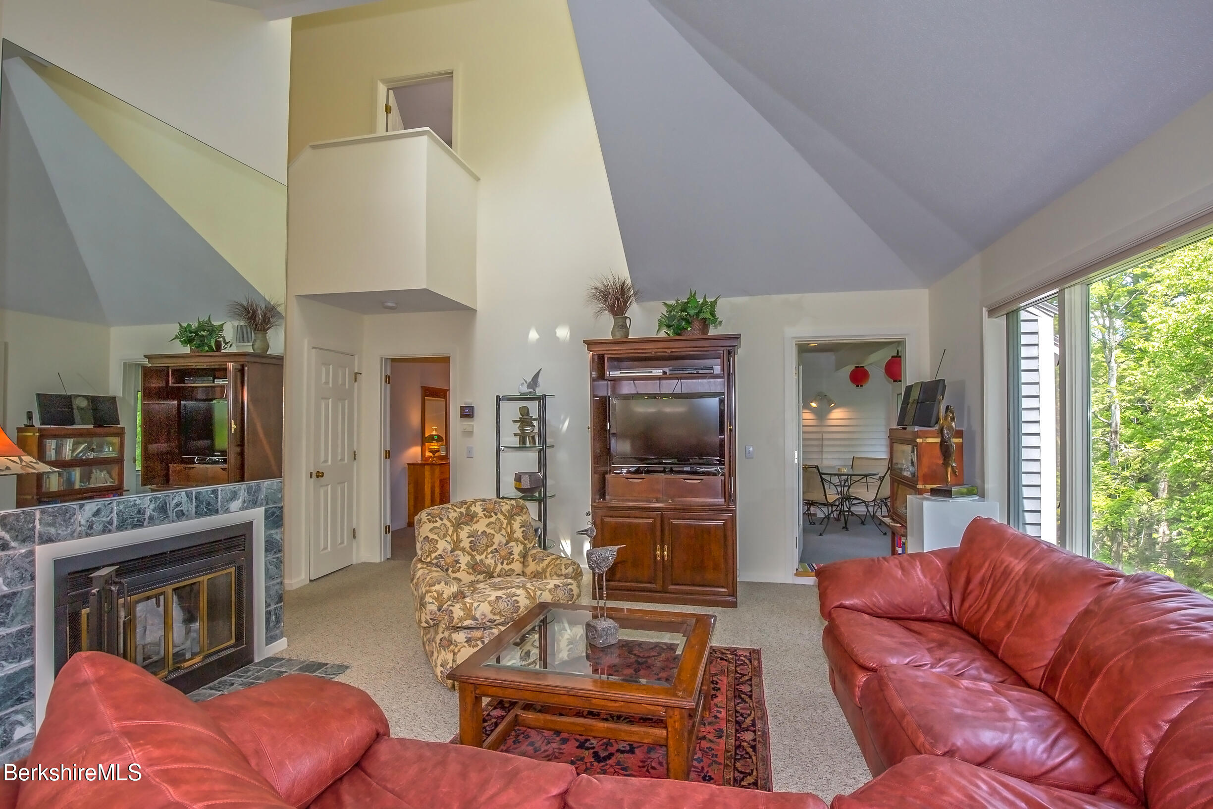 770 Summer Street, Unit 5D Lee, MA 01240 - Photo 8 of 45 a living room with furniture a fireplace and a large window