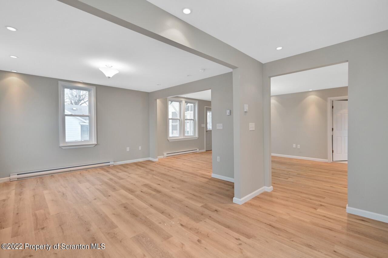 115 West High Street Taylor, PA 18517 - Photo 13 of 38 a view of an empty room with wooden floor and a window