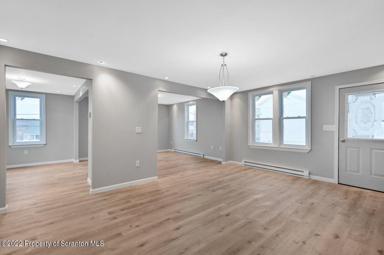 115 West High Street Taylor, PA 18517 - Photo 17 of 38 a view of an empty room with window and wooden floor