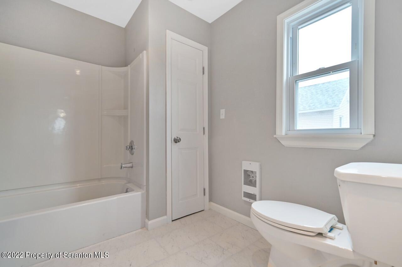 115 West High Street Taylor, PA 18517 - Photo 18 of 38 a bathroom with a toilet and a bathtub