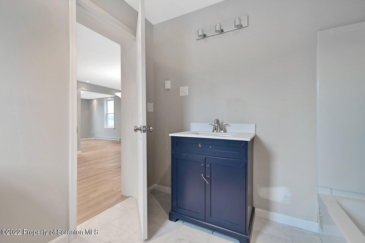 115 West High Street Taylor, PA 18517 - Photo 19 of 38 a bathroom with a sink and a mirror