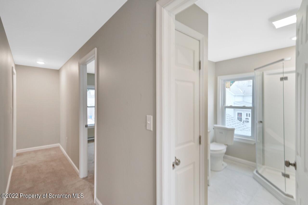 115 West High Street Taylor, PA 18517 - Photo 22 of 38 a bathroom with a glass door shower
