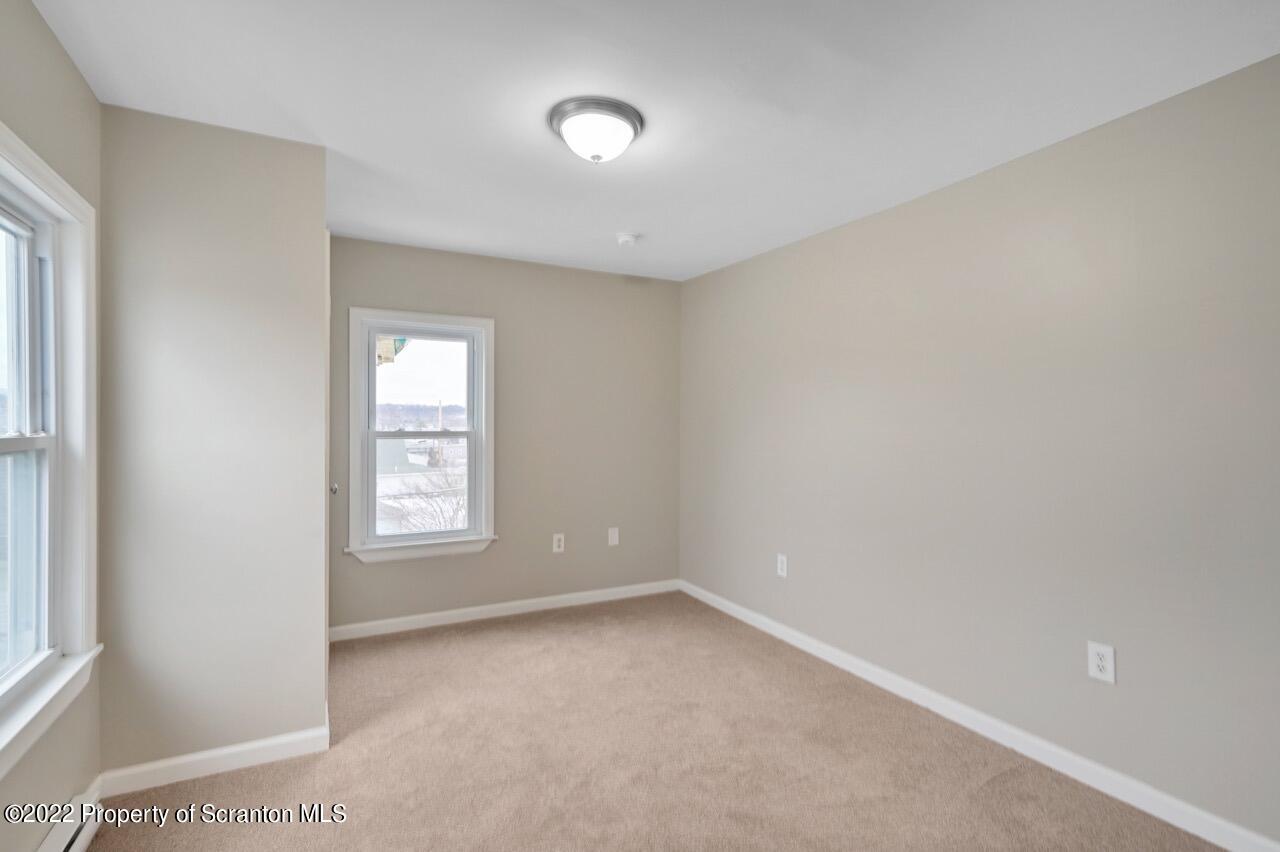 115 West High Street Taylor, PA 18517 - Photo 23 of 38 an empty room with windows
