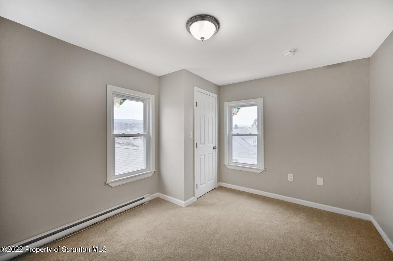 115 West High Street Taylor, PA 18517 - Photo 24 of 38 an empty room with windows and closet