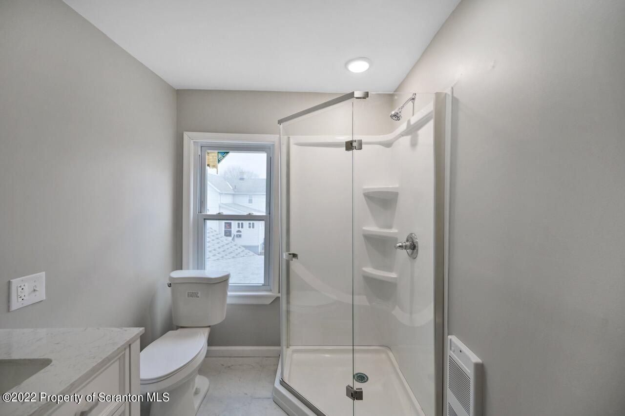 115 West High Street Taylor, PA 18517 - Photo 26 of 38 a bathroom with a shower a toilet and sink