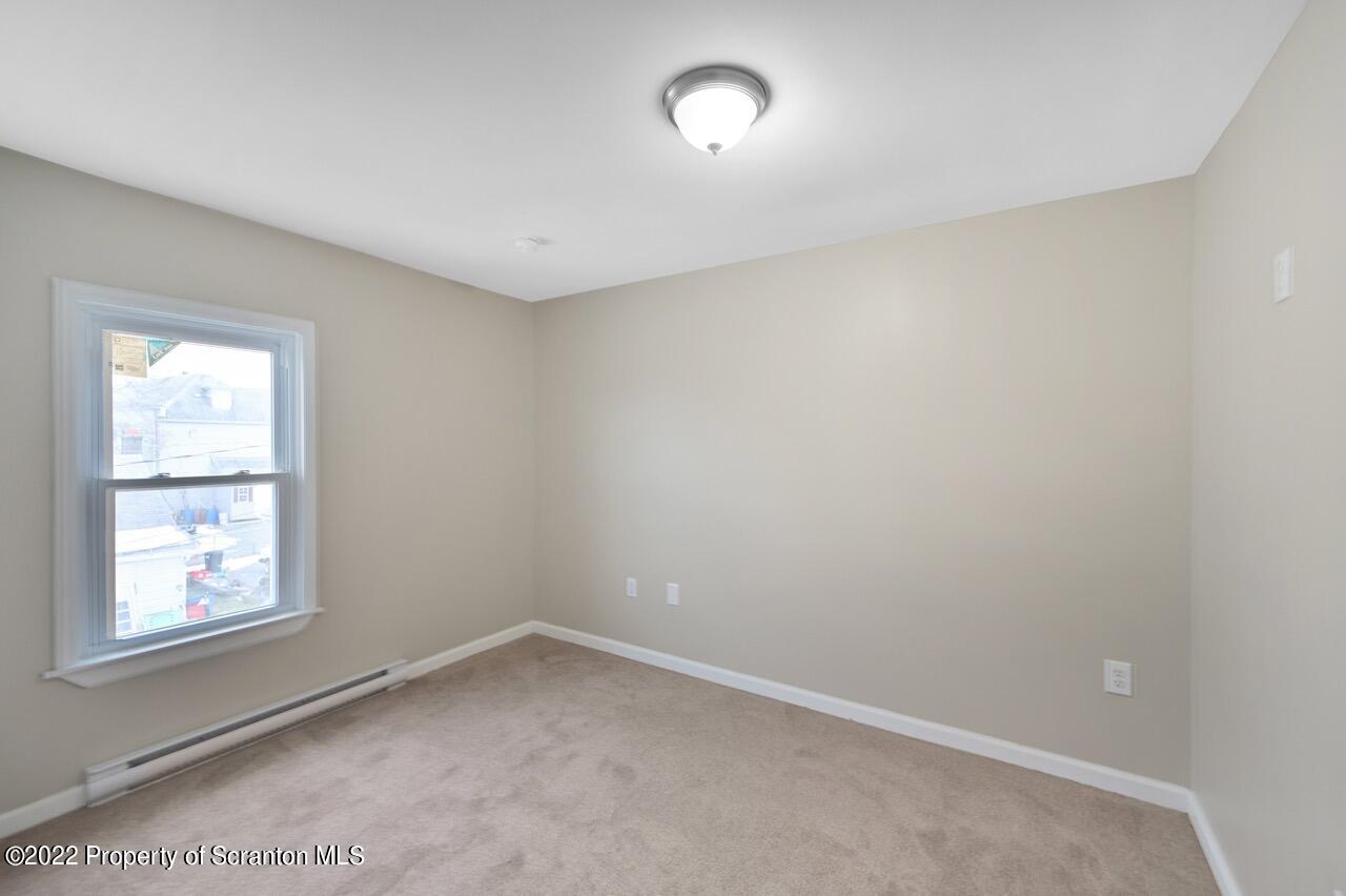 115 West High Street Taylor, PA 18517 - Photo 29 of 38 an empty room with a window