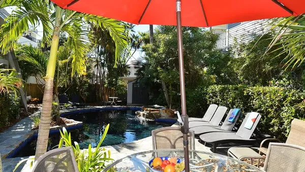 a bathroom with a granite countertop sink a toilet and shower