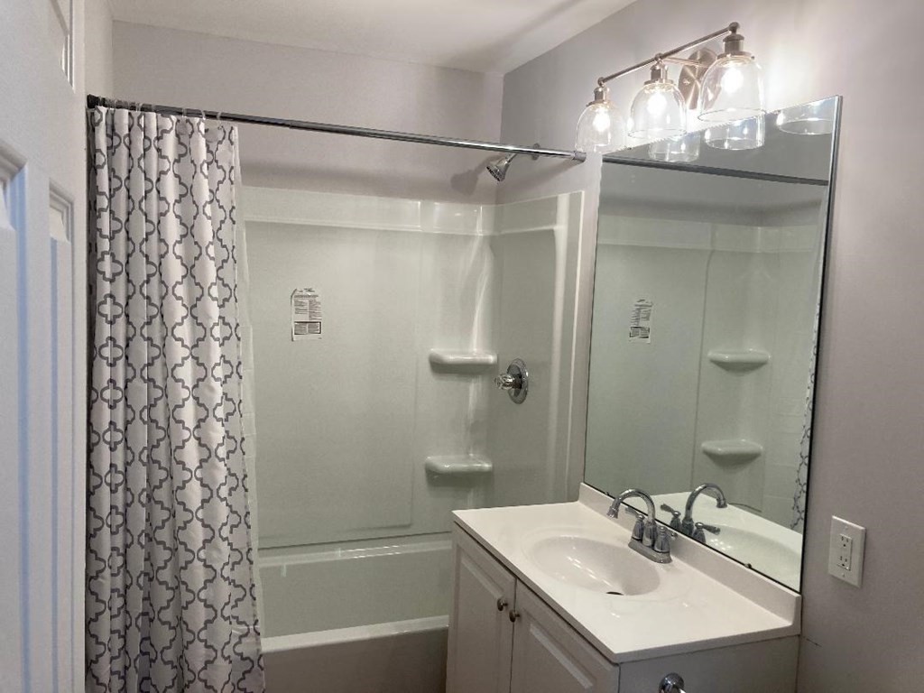 76 Darling Street Springfield, MA 01151 - Photo 8 of 14 a bathroom with a sink shower and a mirror