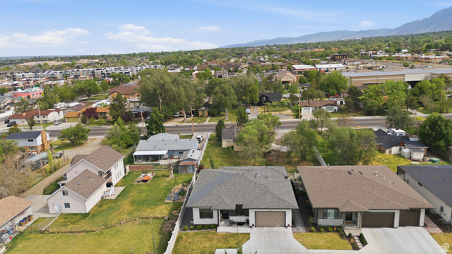 653 East Vandalay Lane Draper, UT 84020 - Photo 52 of 61 Modern residential property featuring a gray shingle roof, attached two-car garage with a brown door, and a concrete driveway