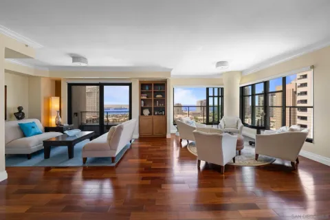 a living room with furniture and large windows