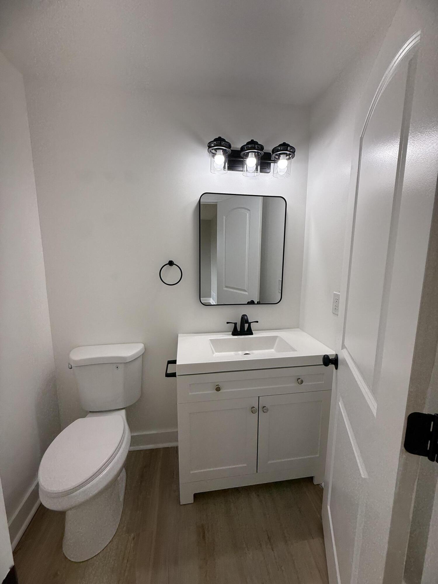 15895 Sherman Street Lowell, IN 46356 - Photo 20 of 36 a bathroom with a toilet sink and mirror