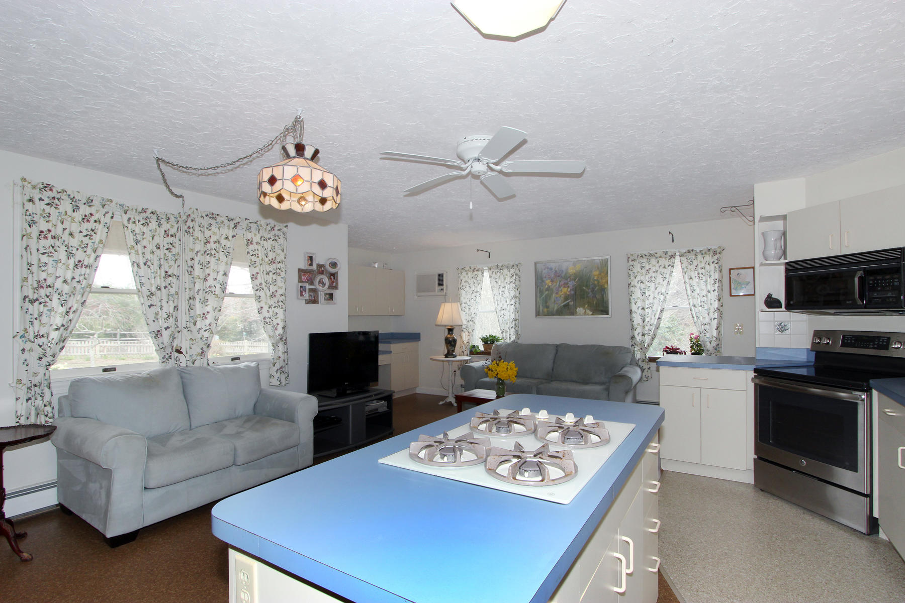 75 Lawton Road Eastham, MA 02642 - Photo 12 of 27 a living room with furniture a fireplace and a flat screen tv