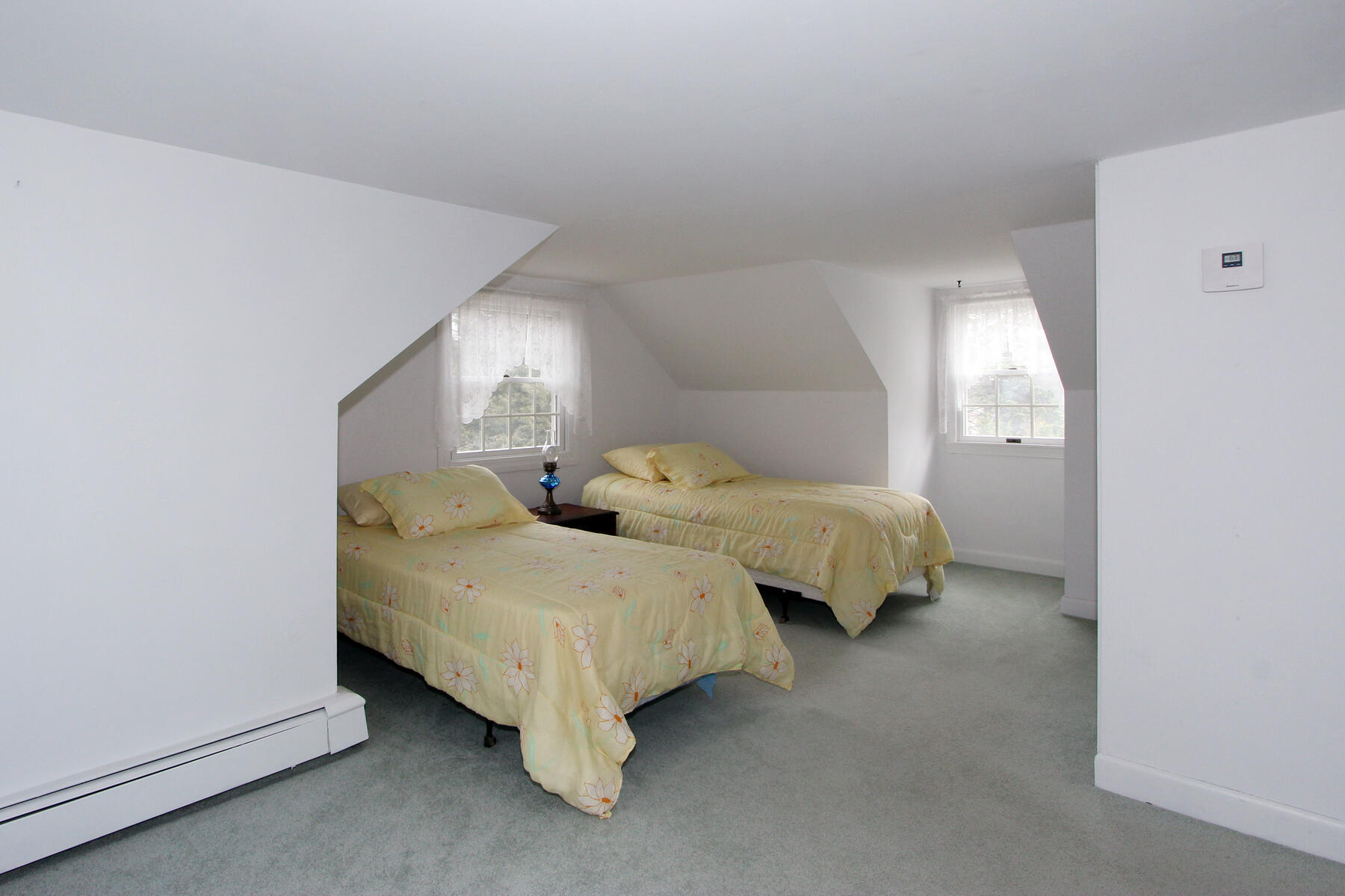 75 Lawton Road Eastham, MA 02642 - Photo 16 of 27 a spacious bedroom with two bed and a lamp