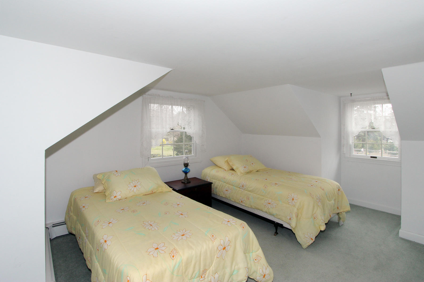 75 Lawton Road Eastham, MA 02642 - Photo 17 of 27 a bedroom with two beds and a lamp