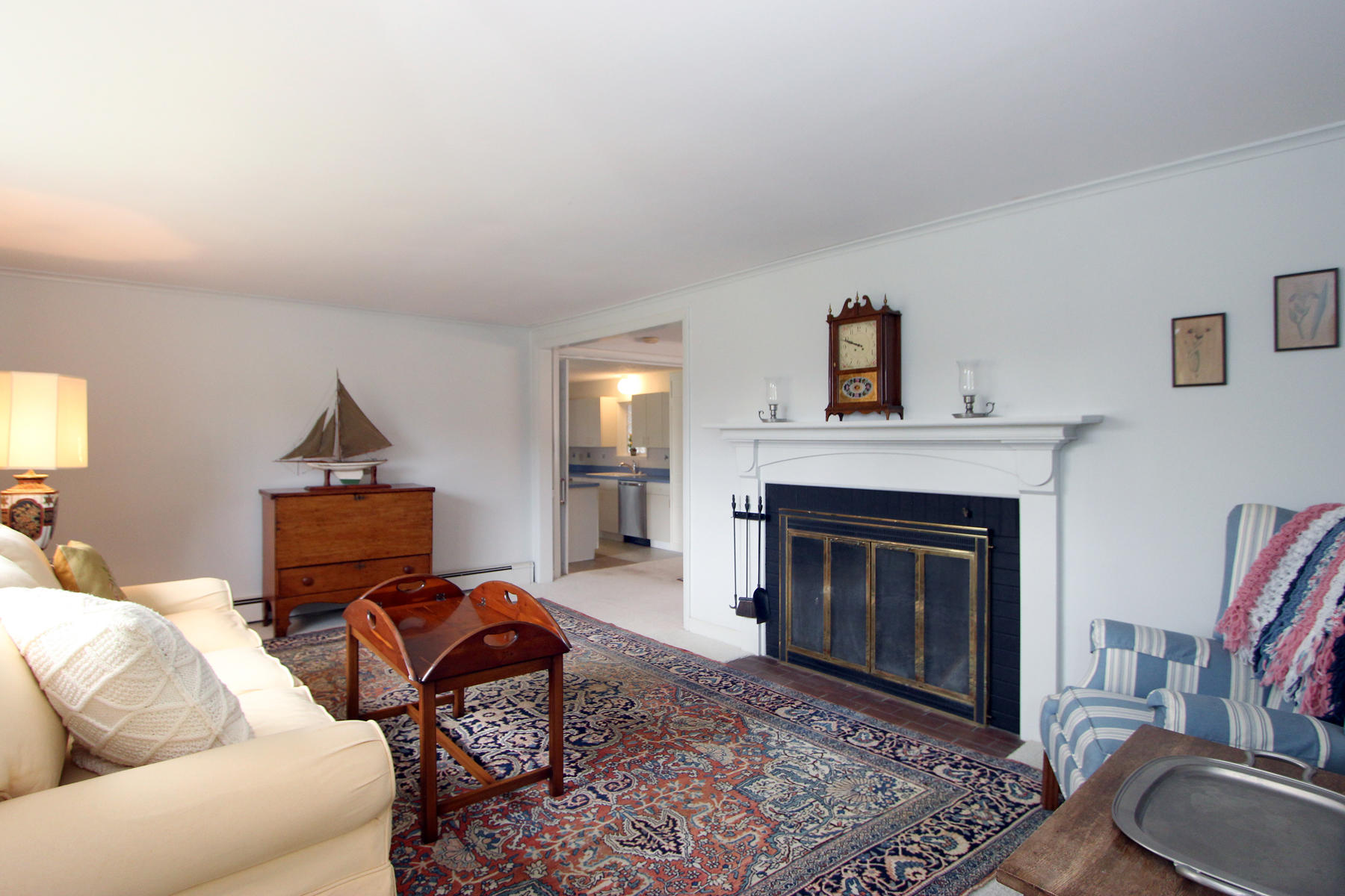 75 Lawton Road Eastham, MA 02642 - Photo 5 of 27 a living room with furniture a rug and a fireplace