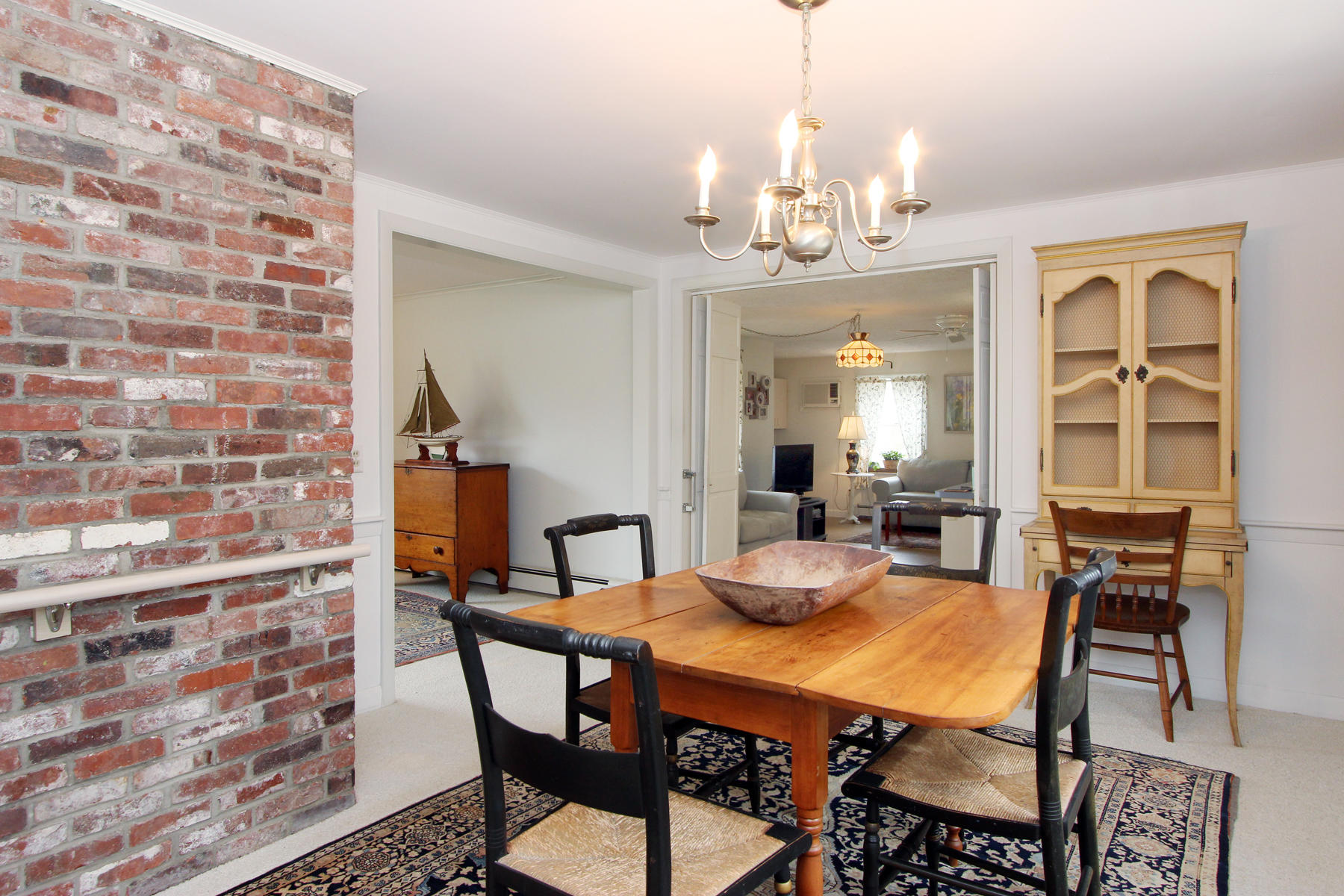 75 Lawton Road Eastham, MA 02642 - Photo 9 of 27 a view of a dining room with furniture and a chandelier
