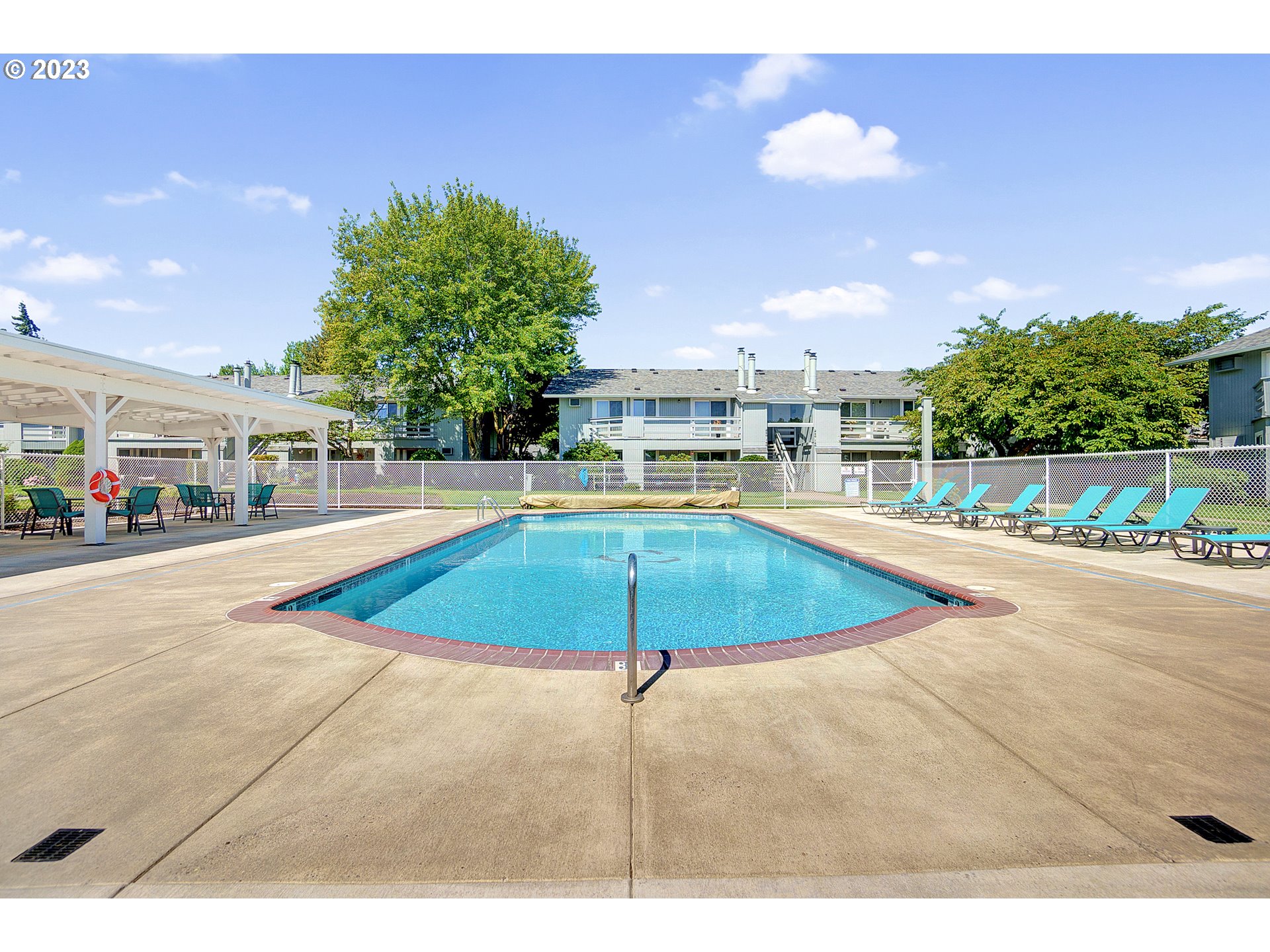650 Harlow Road, Unit 132 Springfield, OR 97477 - Photo 28 of 36 a swimming pool with an outdoor space and seating area