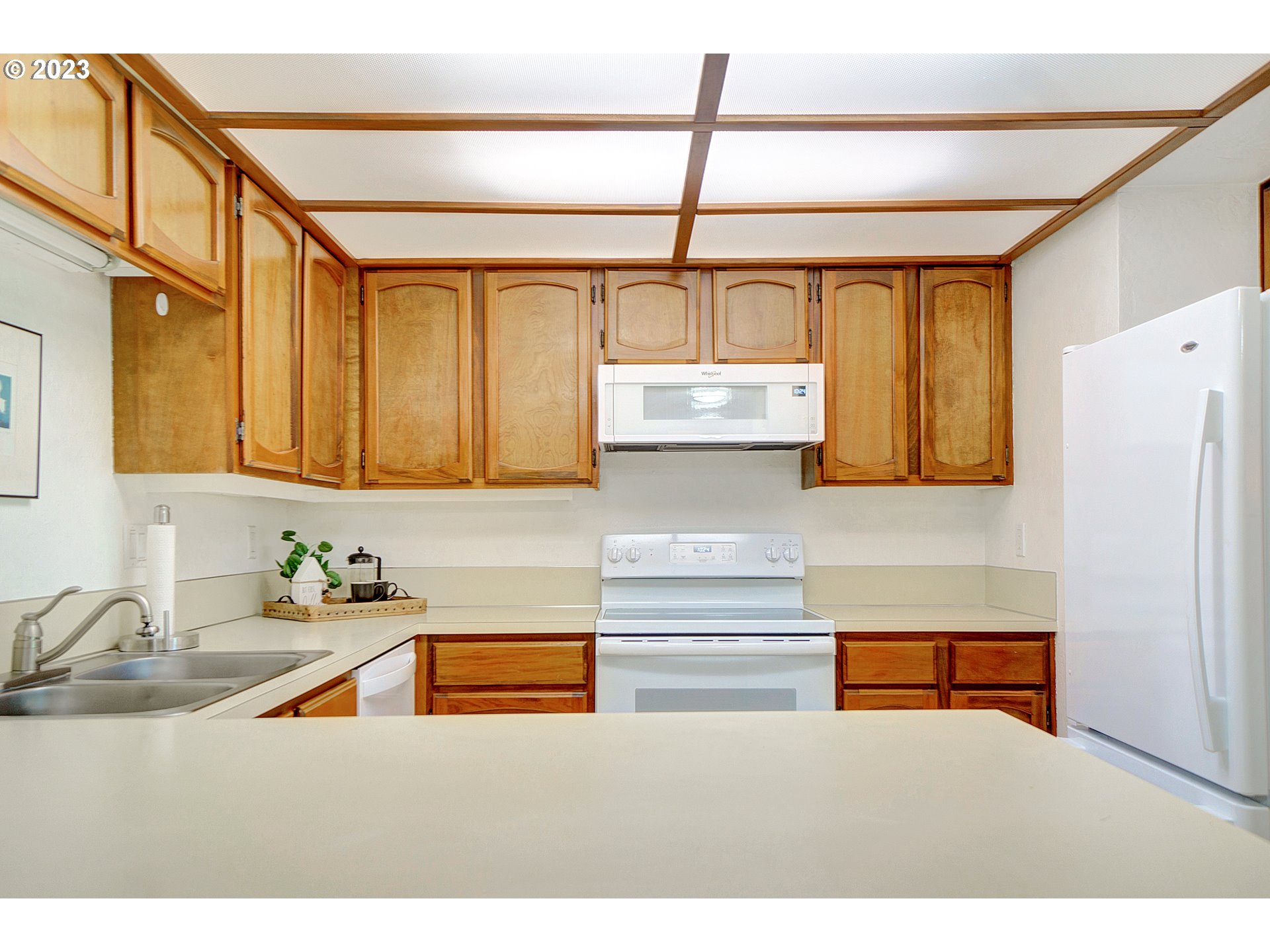 650 Harlow Road, Unit 132 Springfield, OR 97477 - Photo 7 of 36 a kitchen with stainless steel appliances granite countertop a sink and a refrigerator