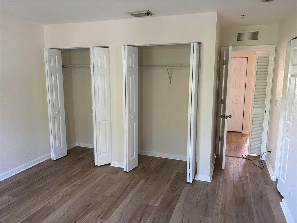 4632 Danson Way Delray Beach, FL 33445 - Photo 11 of 26 an empty room with wooden floor and closet