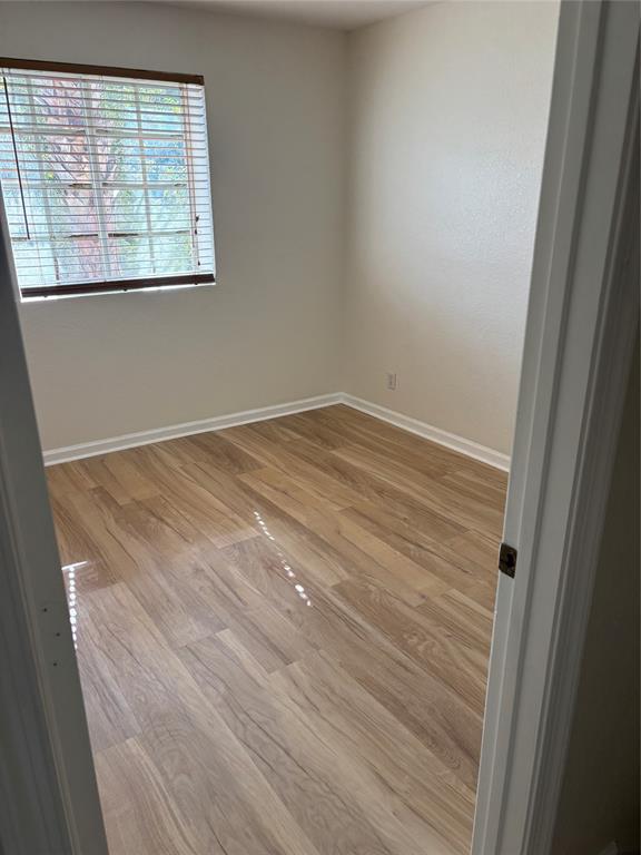 4632 Danson Way Delray Beach, FL 33445 - Photo 12 of 26 an empty room with wooden floor and windows