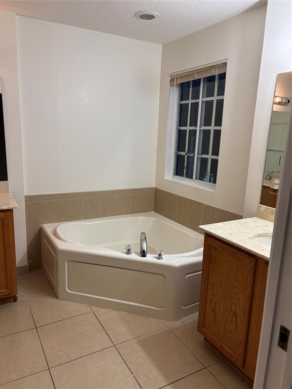 4632 Danson Way Delray Beach, FL 33445 - Photo 20 of 26 a spacious bathroom with a bathtub and window