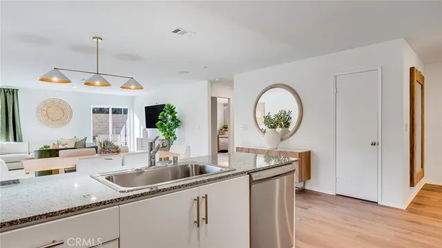a kitchen with a sink and a clock