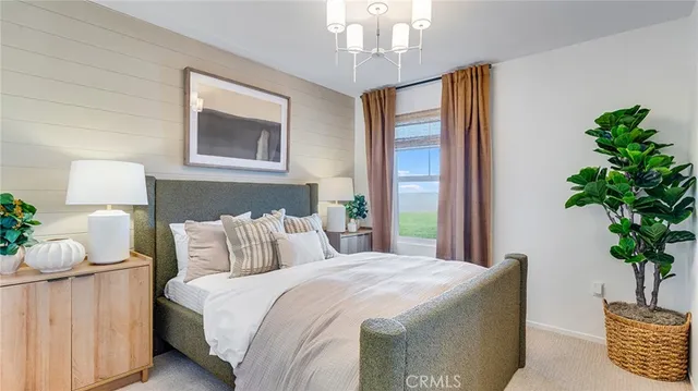 a bedroom with a large bed and a potted plant