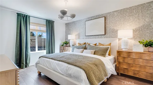 a large bed sitting in a bedroom next to a window