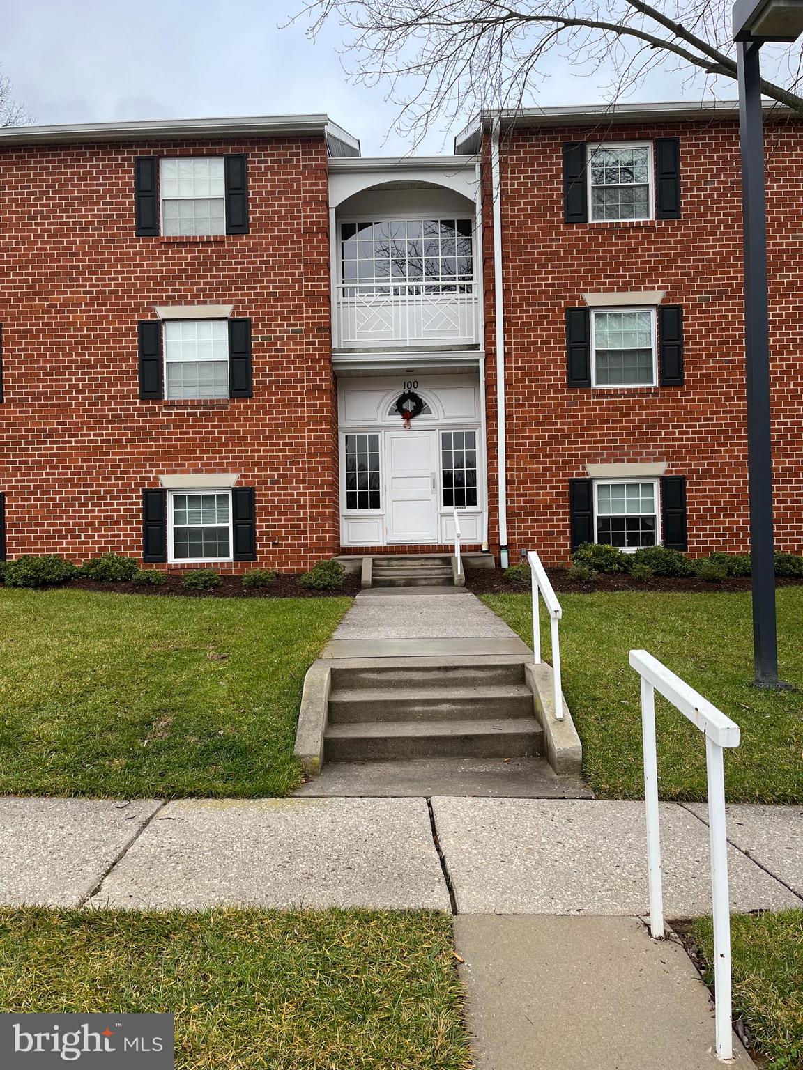100 Castletown Road, Unit 101 Lutherville-Timonium, MD 21093 - Photo 1 of 18 a view of a brick house with a yard