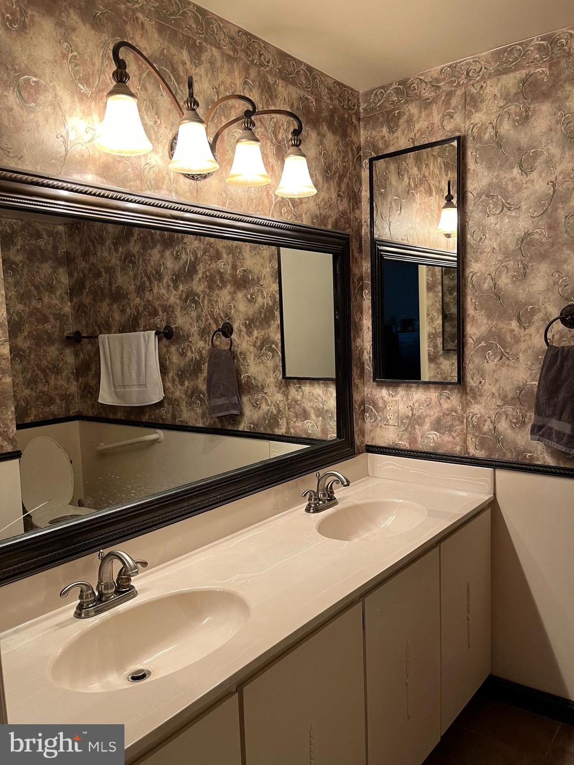 100 Castletown Road, Unit 101 Lutherville-Timonium, MD 21093 - Photo 11 of 18 a bathroom with a sink and a mirror
